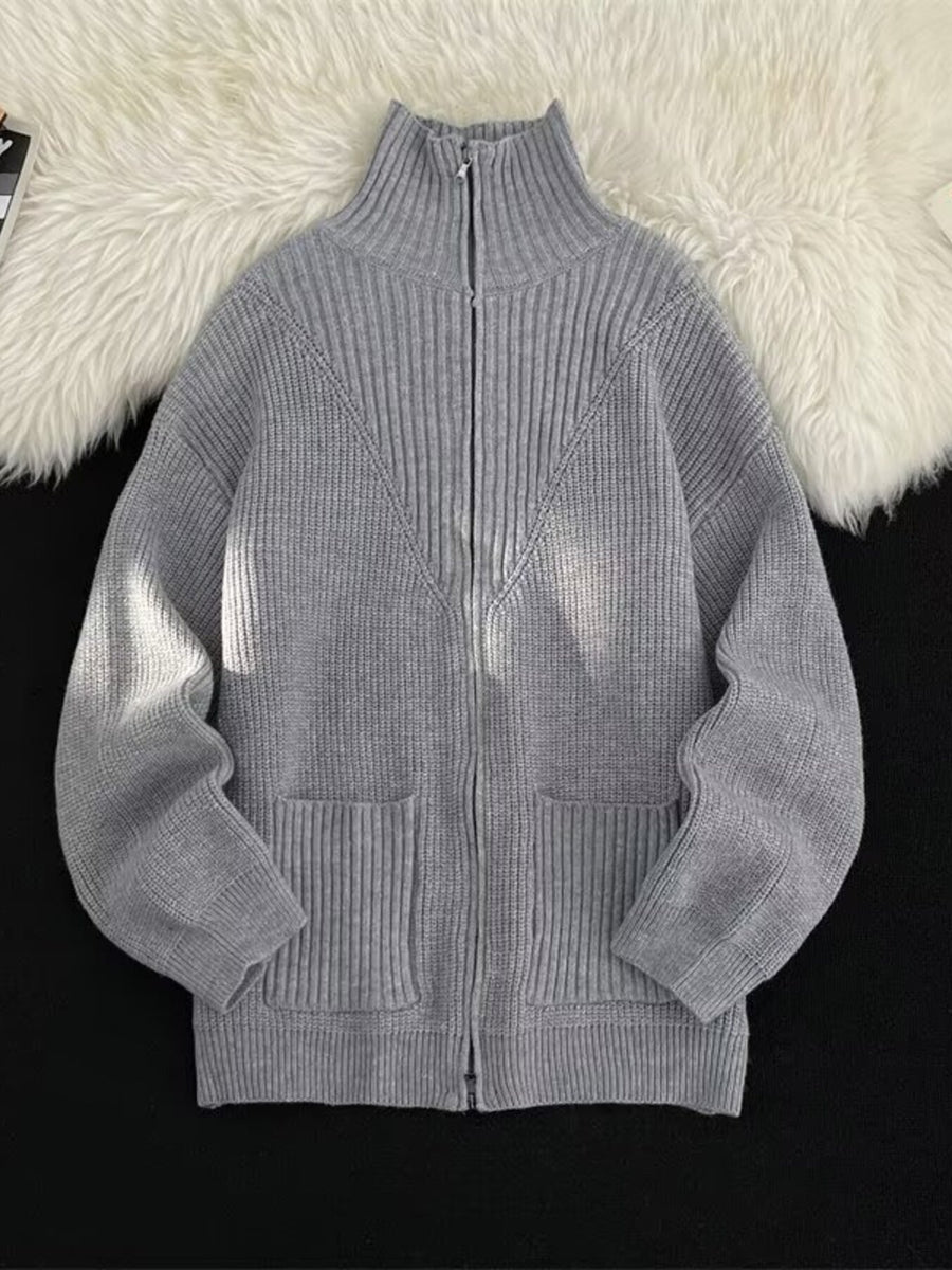 Grey ribbed zip-up sweater with high neck and pockets