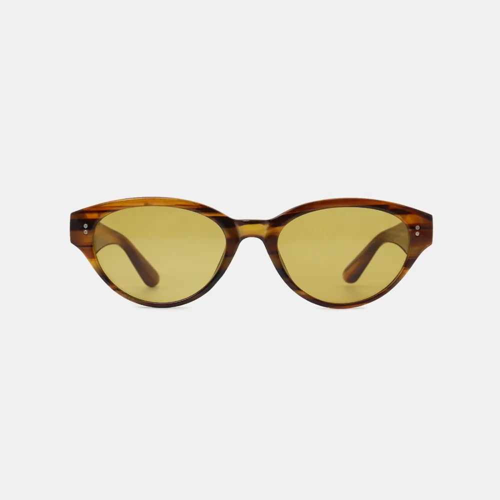 Tortoiseshell oval acetate sunglasses with yellow lenses and brown frames.