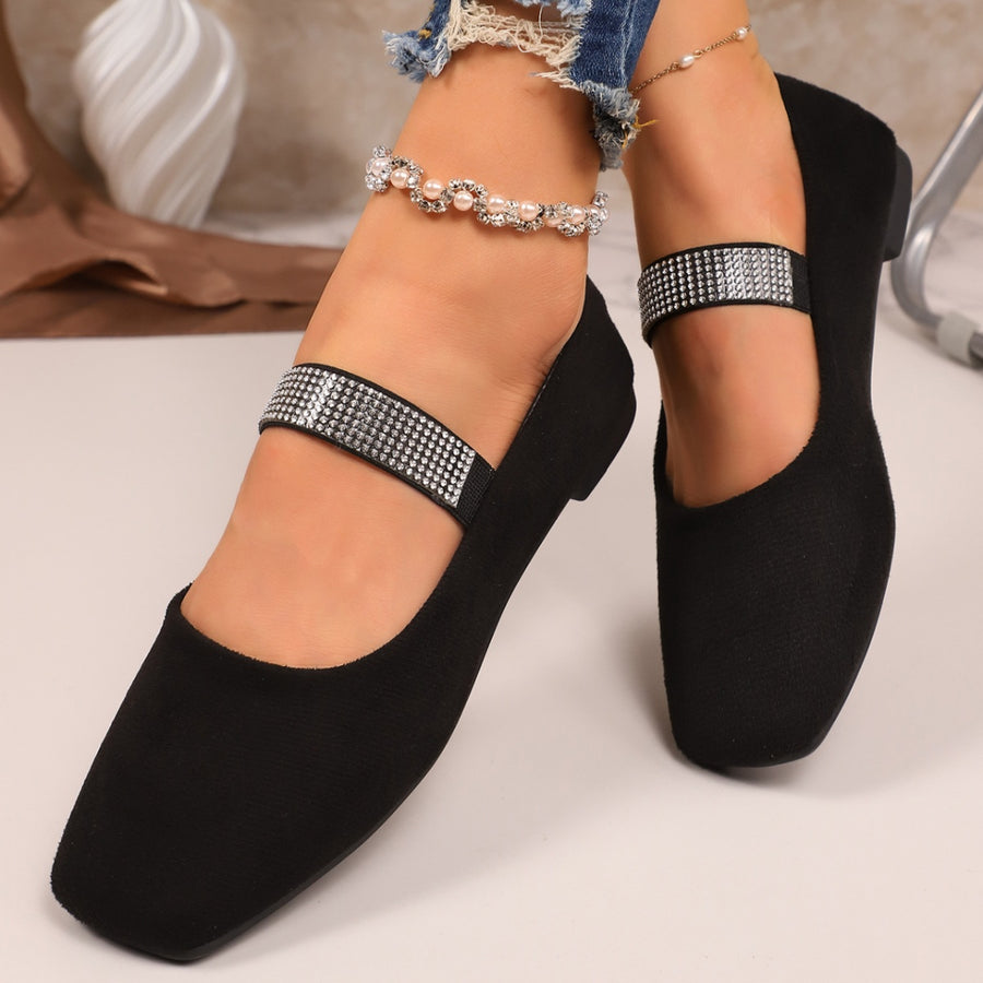 Black square toe slip-on flats with embellished strap and pearl anklet.