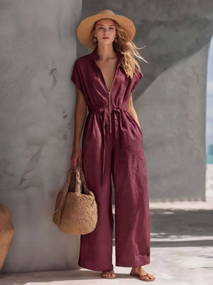 Burgundy wide-leg jumpsuit with zipper front, short sleeves, and drawstring waist.
