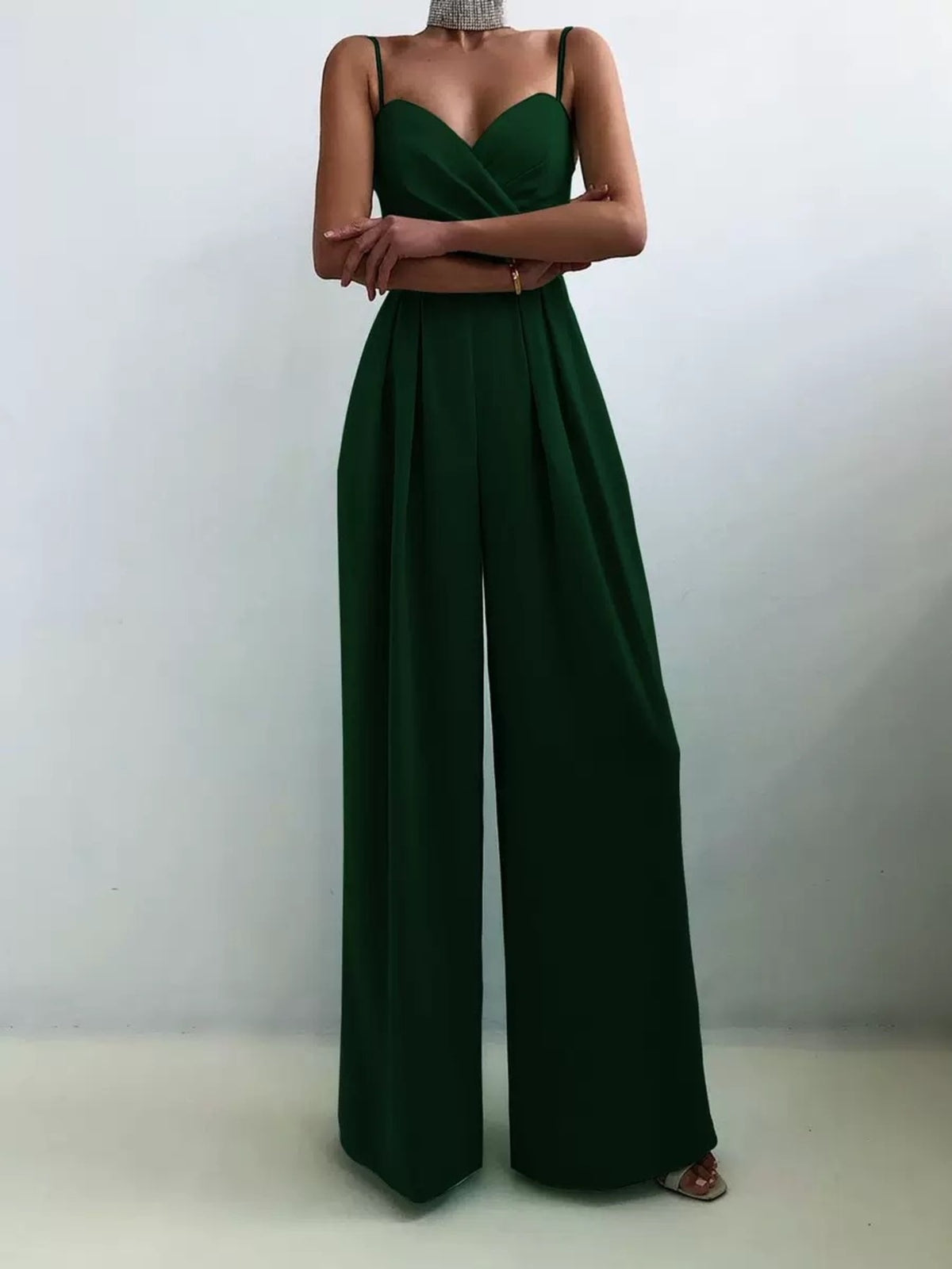 Dark green ruched spaghetti strap wide-leg jumpsuit with sweetheart neckline and high waist.