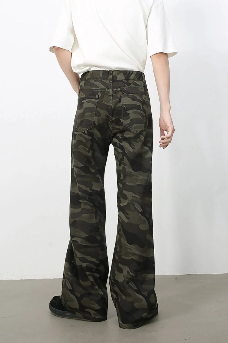 Camo flare denim trousers in green camouflage with a casual, wide-leg cut.