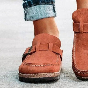 Caramel suede buckle mule loafers with contrast stitching and cork sole.