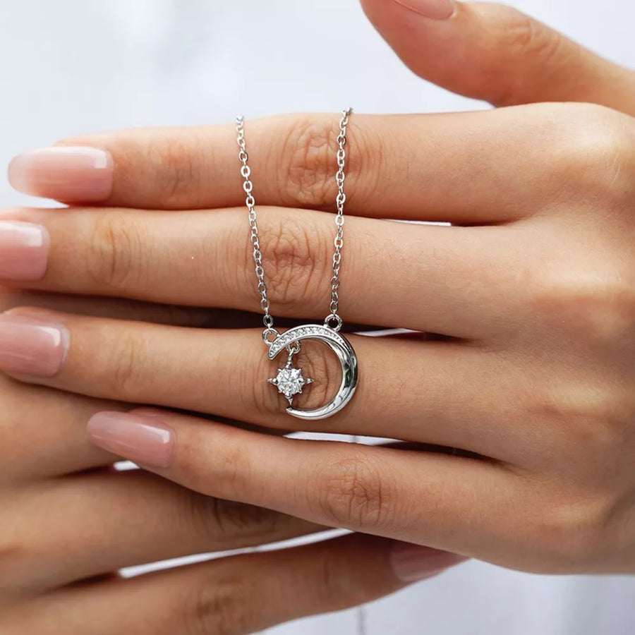 Celestial moissanite crescent necklace with a star charm, delicate silver chain.