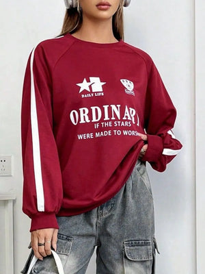 Deep red raglan sleeve sweatshirt with white stripe details and varsity graphic.