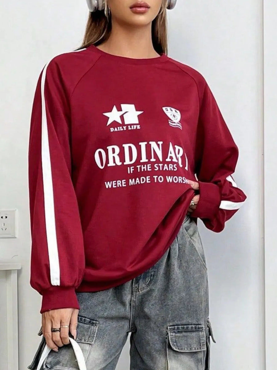 Deep red raglan sleeve sweatshirt with white stripe details and varsity graphic.