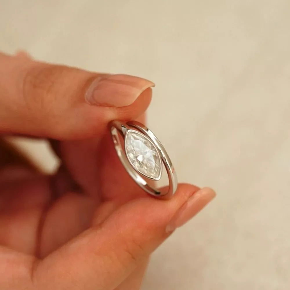 Elegant marquise moissanite bypass ring in silver with a clear center stone.