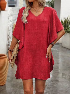Red V-neck mini dress with flowy sleeves and textured fabric.