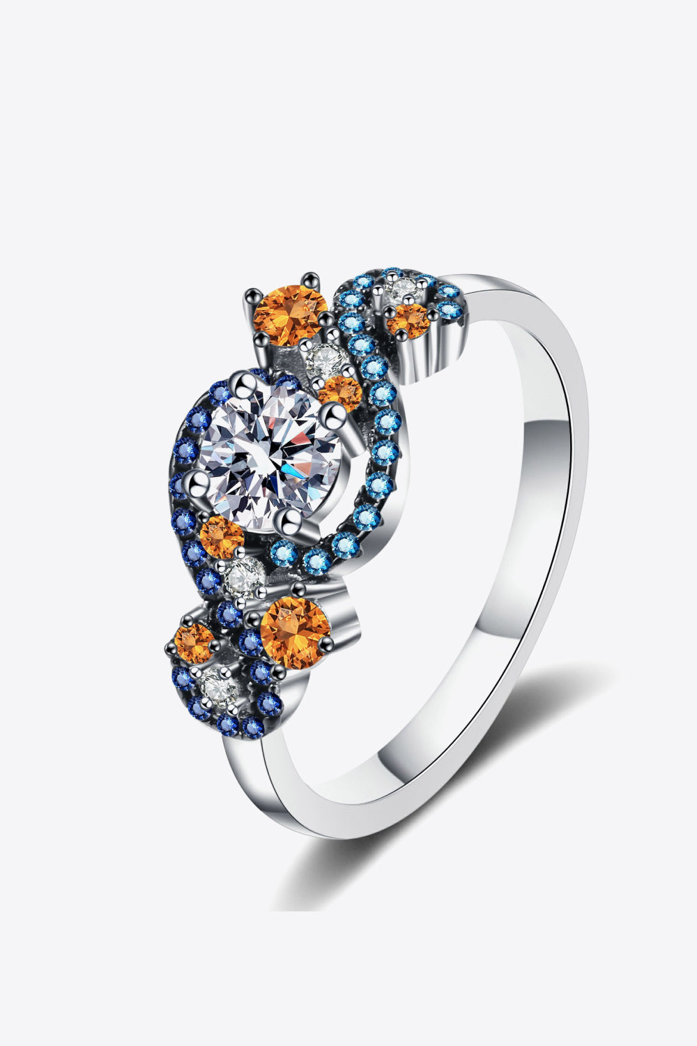 Silver ring with a central diamond and swirling accents of orange, blue, and clear gemstones.