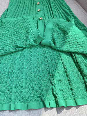 Green knit dress with Peter Pan collar and gold buttons, featuring a diamond pattern.