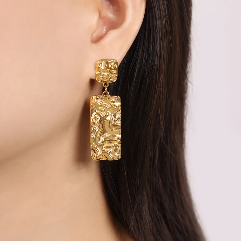 Gold crinkle drop earrings with textured rectangular pendants.
