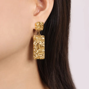 Gold crinkle drop earrings with textured rectangular pendants.