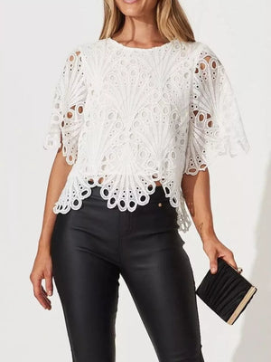 White lace half-sleeve blouse with intricate eyelet pattern and scalloped hem.