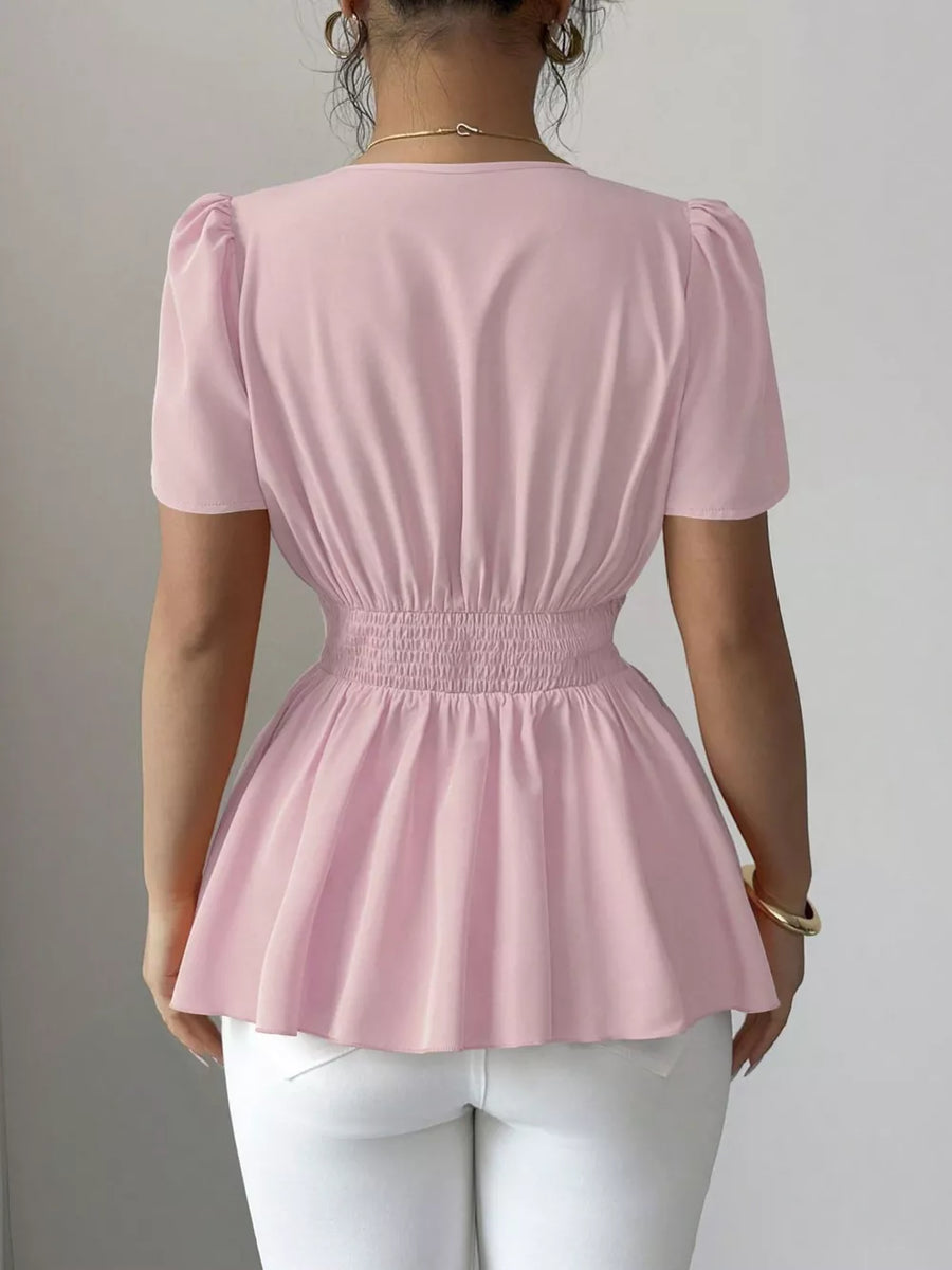 Pink peplum blouse with smocked waist and puff sleeves