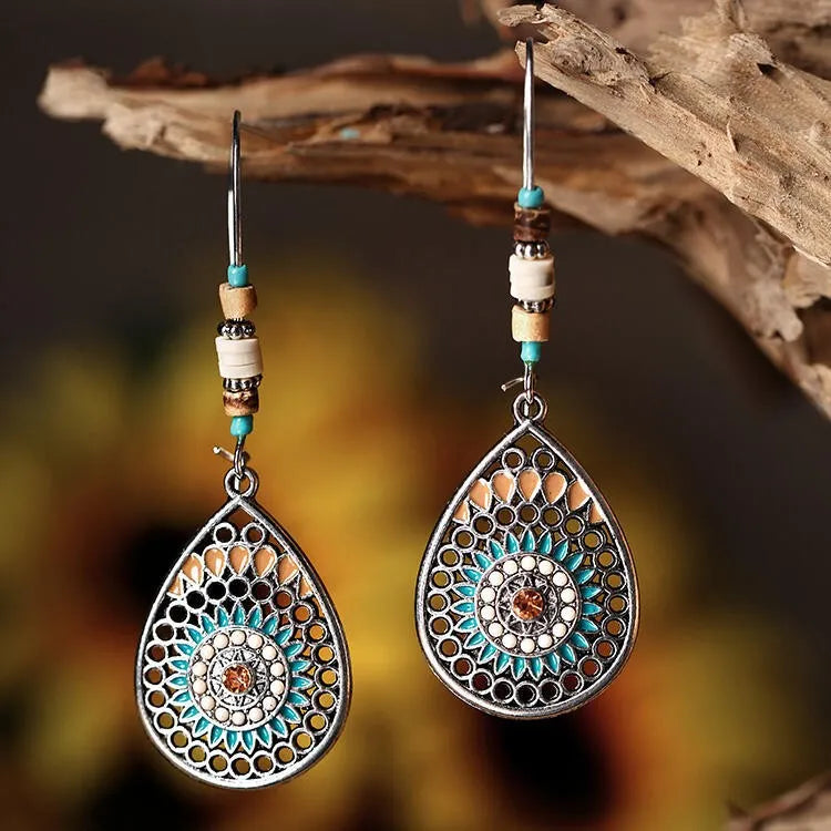 Bohemian silver drop earrings with mandala design, turquoise and tan enamel, and wood beads.