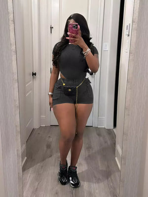 Chic ribbed black crop top and shorts set with pockets and gold chain detail.