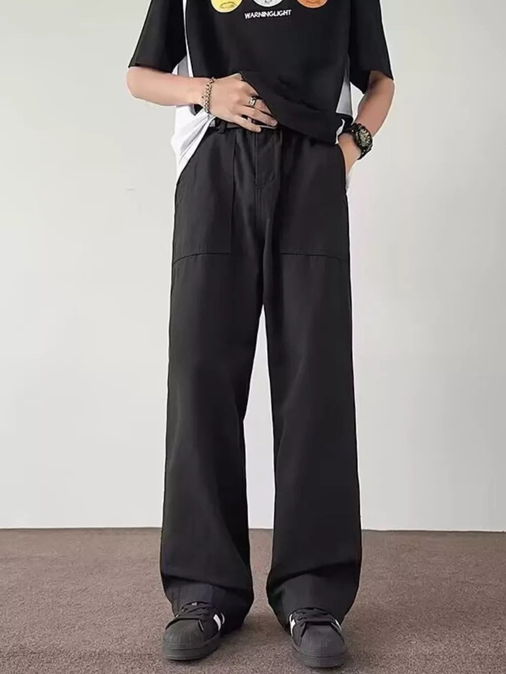 Black casual wide-leg cargo pants for men with large front pockets and a relaxed fit.