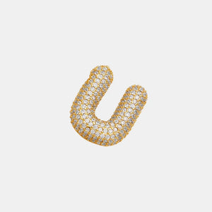 Puffed gold initial necklace with clear zirconia stones, delicate chain detail.