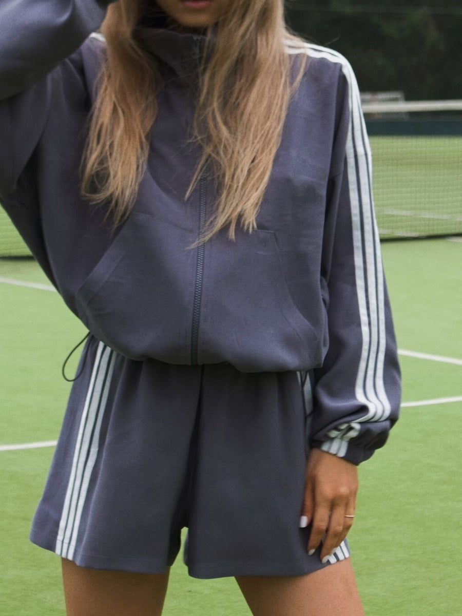 Grey track jacket featuring ribbed and striped