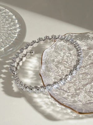 Silver double row pavé bangle bracelet with clear stones.