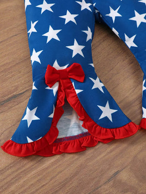 Patriotic baby flare pants with red bow and ruffle trim, blue with white stars.