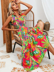 Tropical tie-strap smocked midi dress in strawberry with vibrant leaf print.
