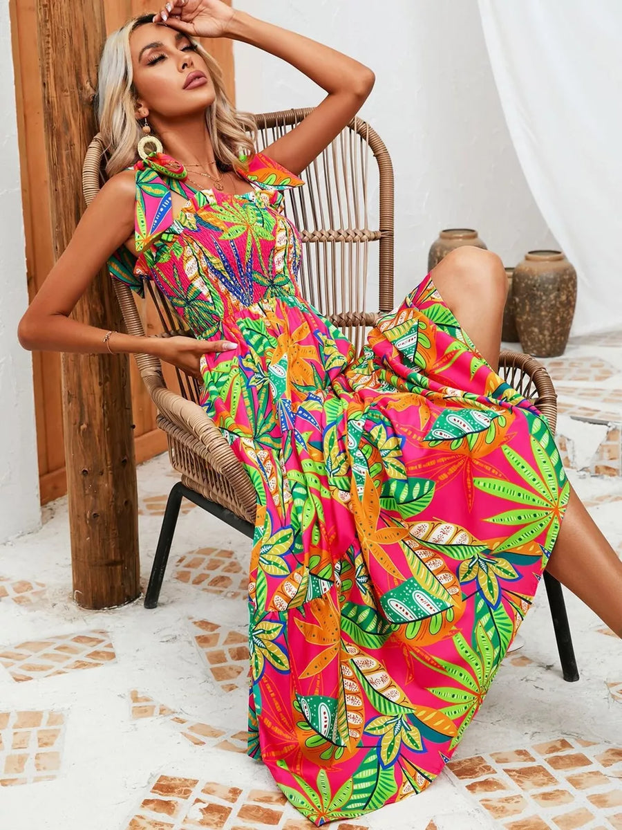 Tropical tie-strap smocked midi dress in strawberry with vibrant leaf print.