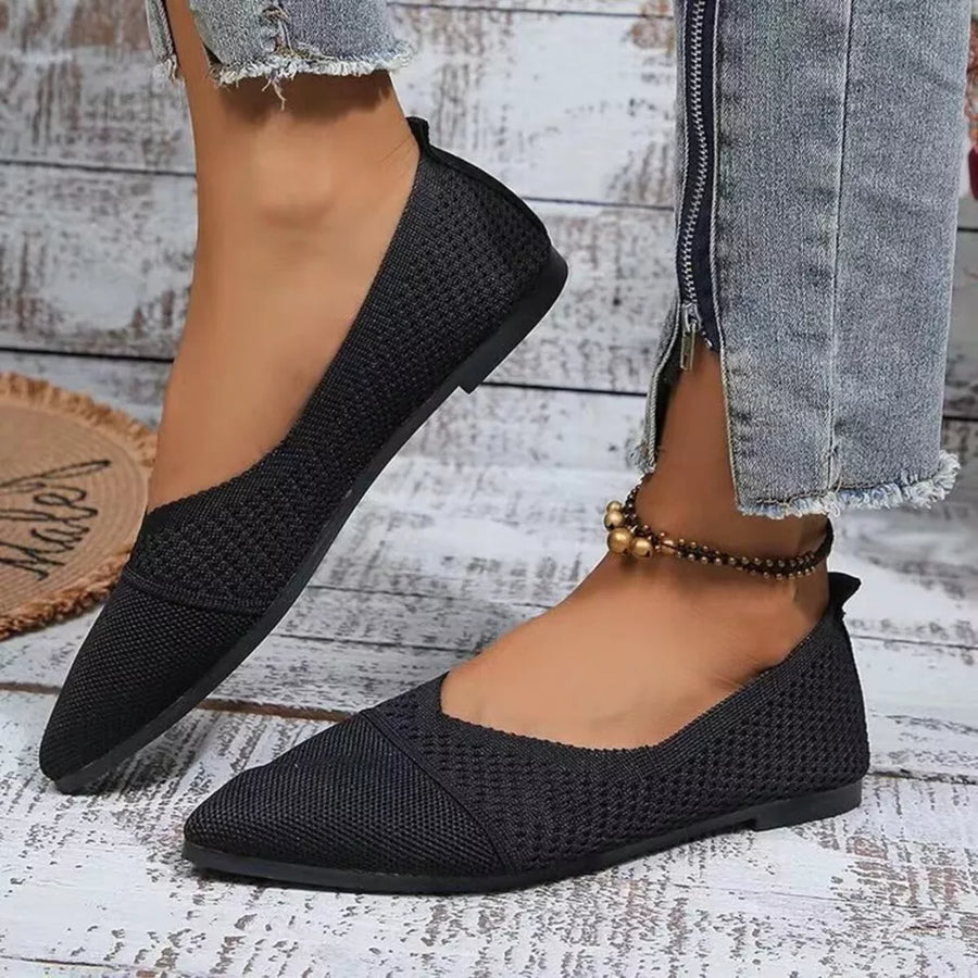 Black knit pointed toe flats with a low heel.