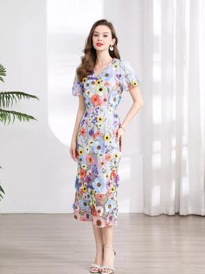 Sheath dress with V-neck, short sleeves, and floral embroidery in pastel colors.