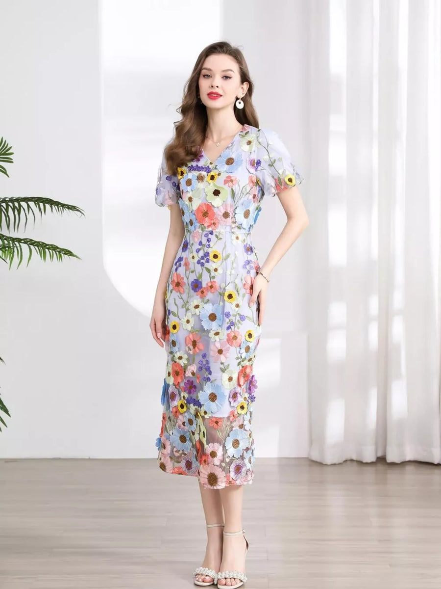 Sheath dress with V-neck, short sleeves, and floral embroidery in pastel colors.