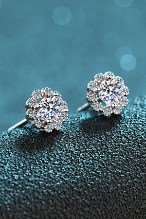 Floral halo stud earrings in silver with sparkling stones.