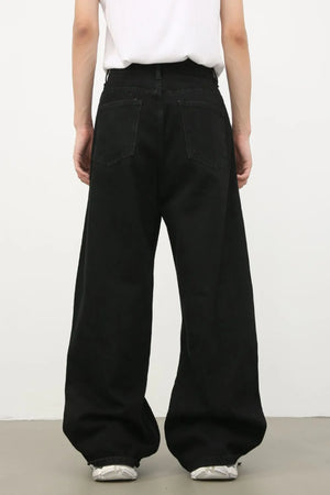 Black denim jeans with exaggerated wide legs and a tie detail