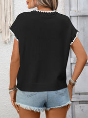 Black ribbed short-sleeve sweater with white contrast trim neckline and cuffs.