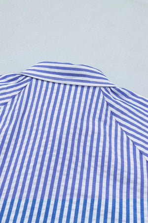 Striped button-down blouse with a textured fabric and classic collar.