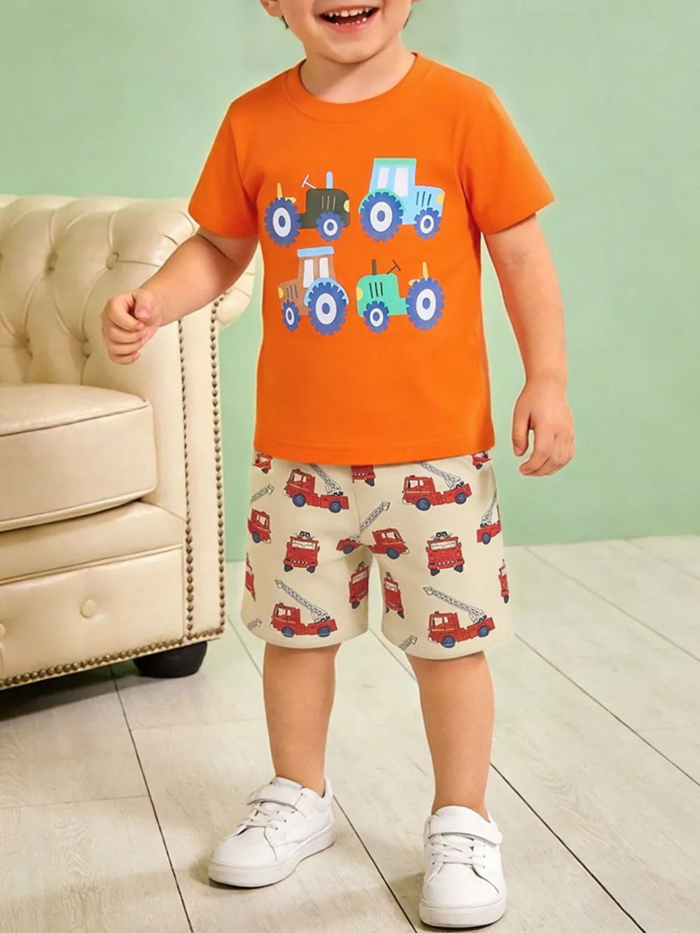 Boys' cotton underwear set with orange tractor print t-shirt and beige firetruck print shorts.