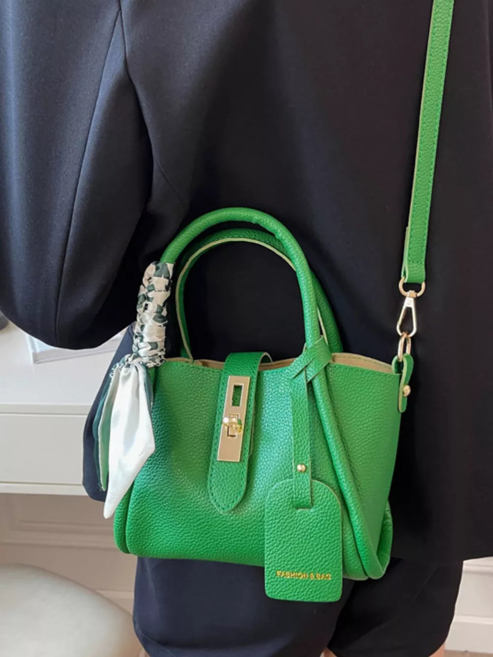 Green mini crossbody bag with scarf detail and gold hardware