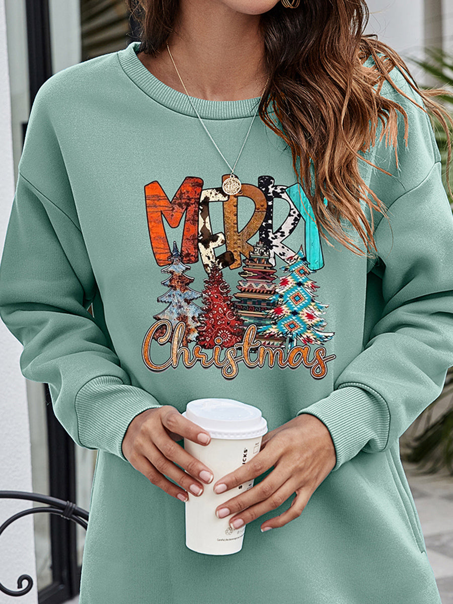 Sage extended hemline sweatshirt with "Merry Christmas" graphic and festive trees.