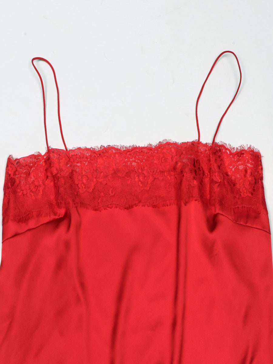 Red satin cami top with lace trim detail and thin spaghetti straps.