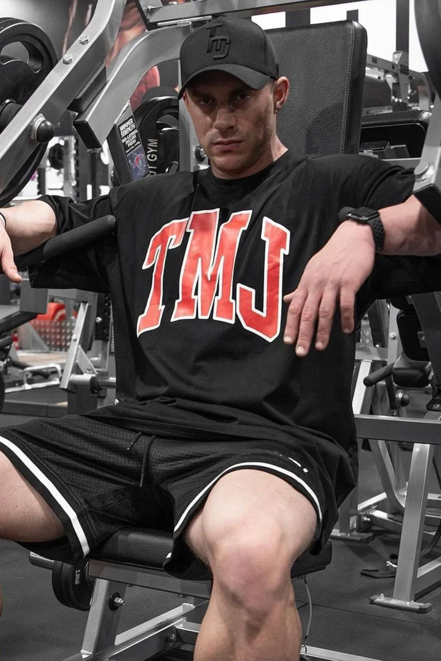Black oversized graphic tee with red TMJ lettering, athletic fit