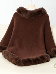 Chocolate knit poncho with faux fur trim at neckline and hem.