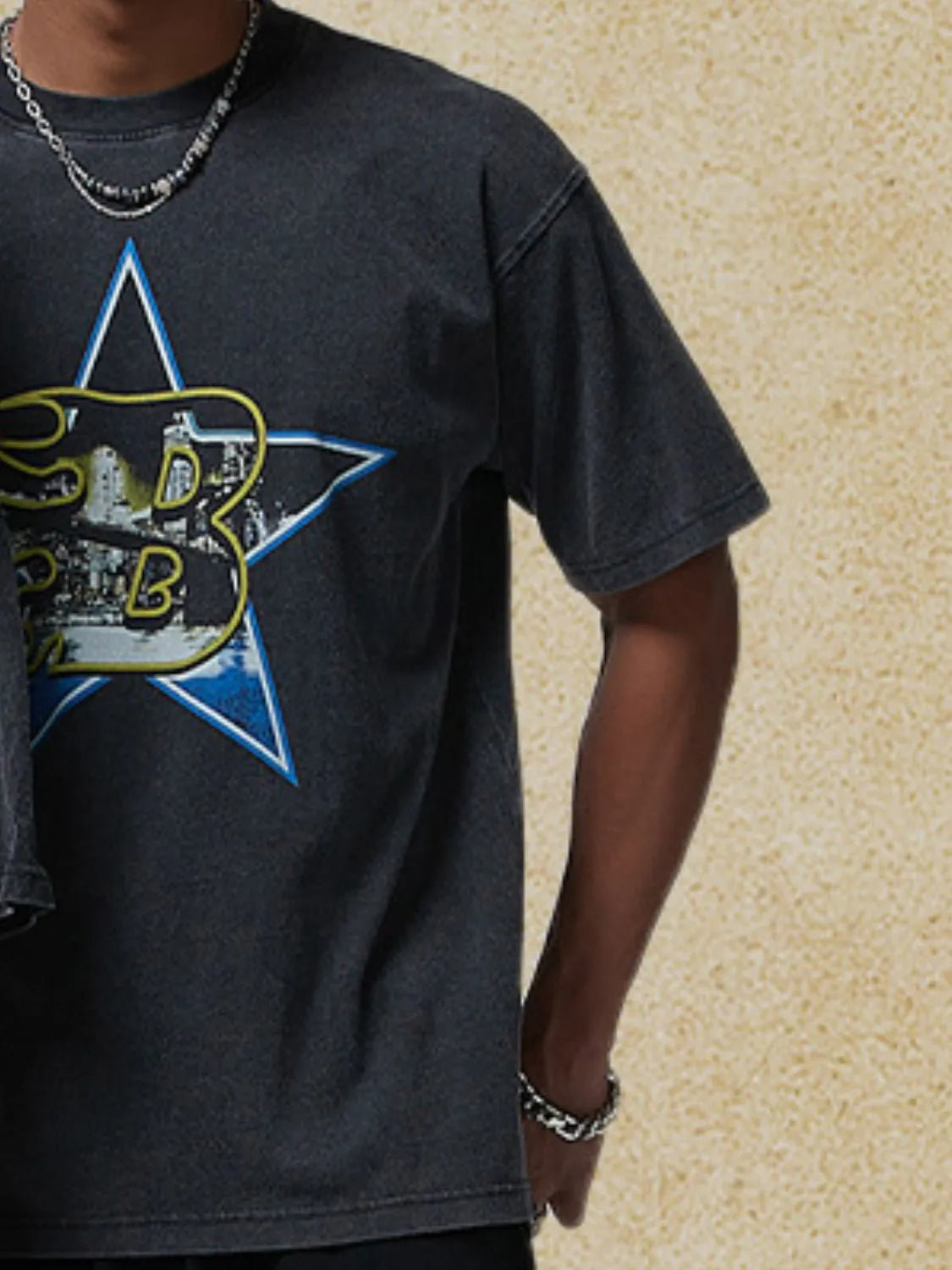 Black graphic t-shirt with a vintage star design and short sleeves.