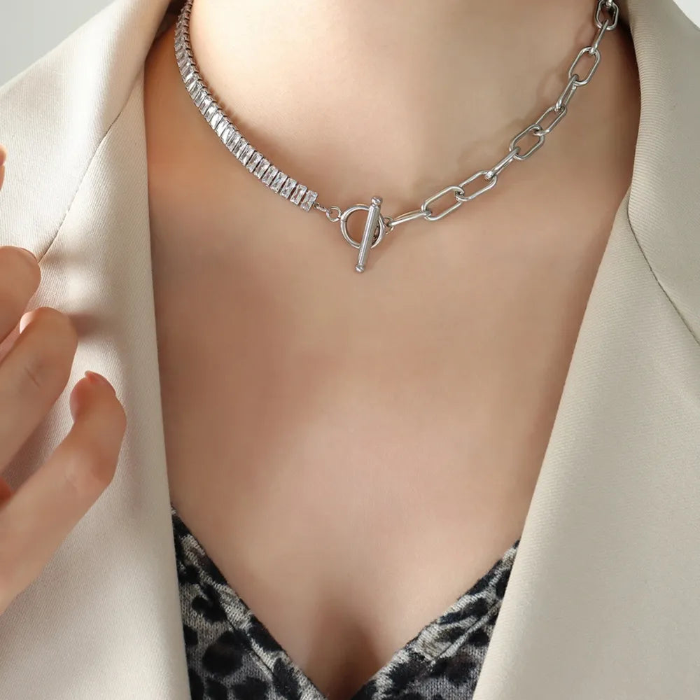Silver asymmetric crystal link necklace with toggle closure and baguette-cut stones