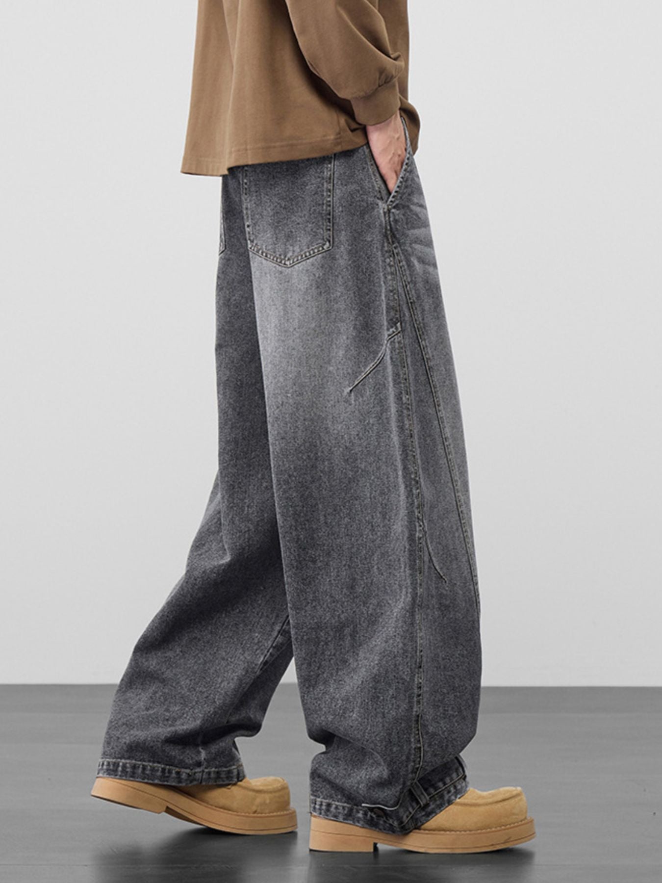 Men's baggy vintage wash jeans in dark cotton denim with cinched hems.
