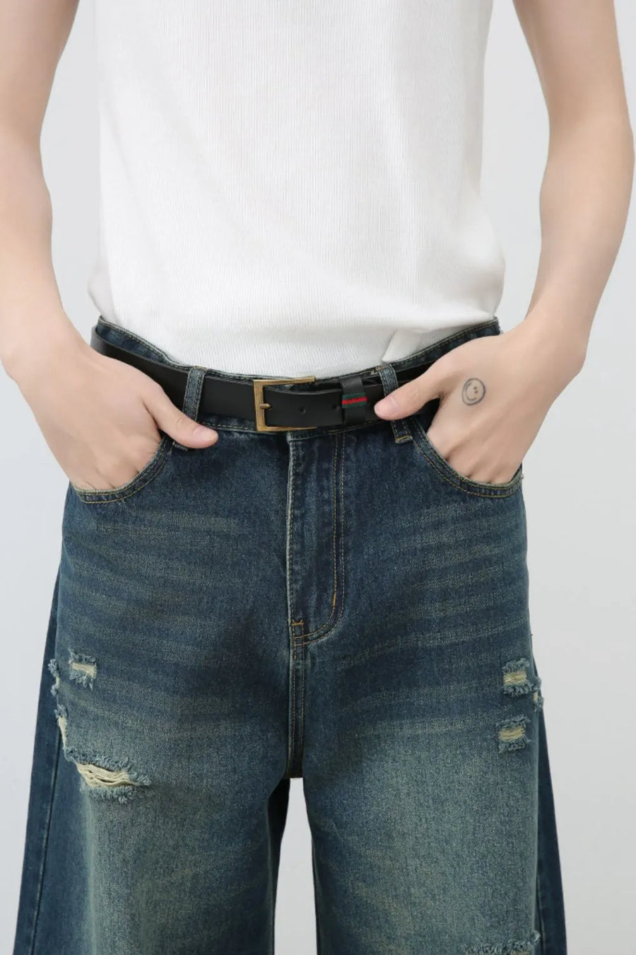 Distressed baggy denim jeans in dark wash with ripped details.