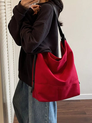 Red canvas hobo bag with adjustable strap and casual style