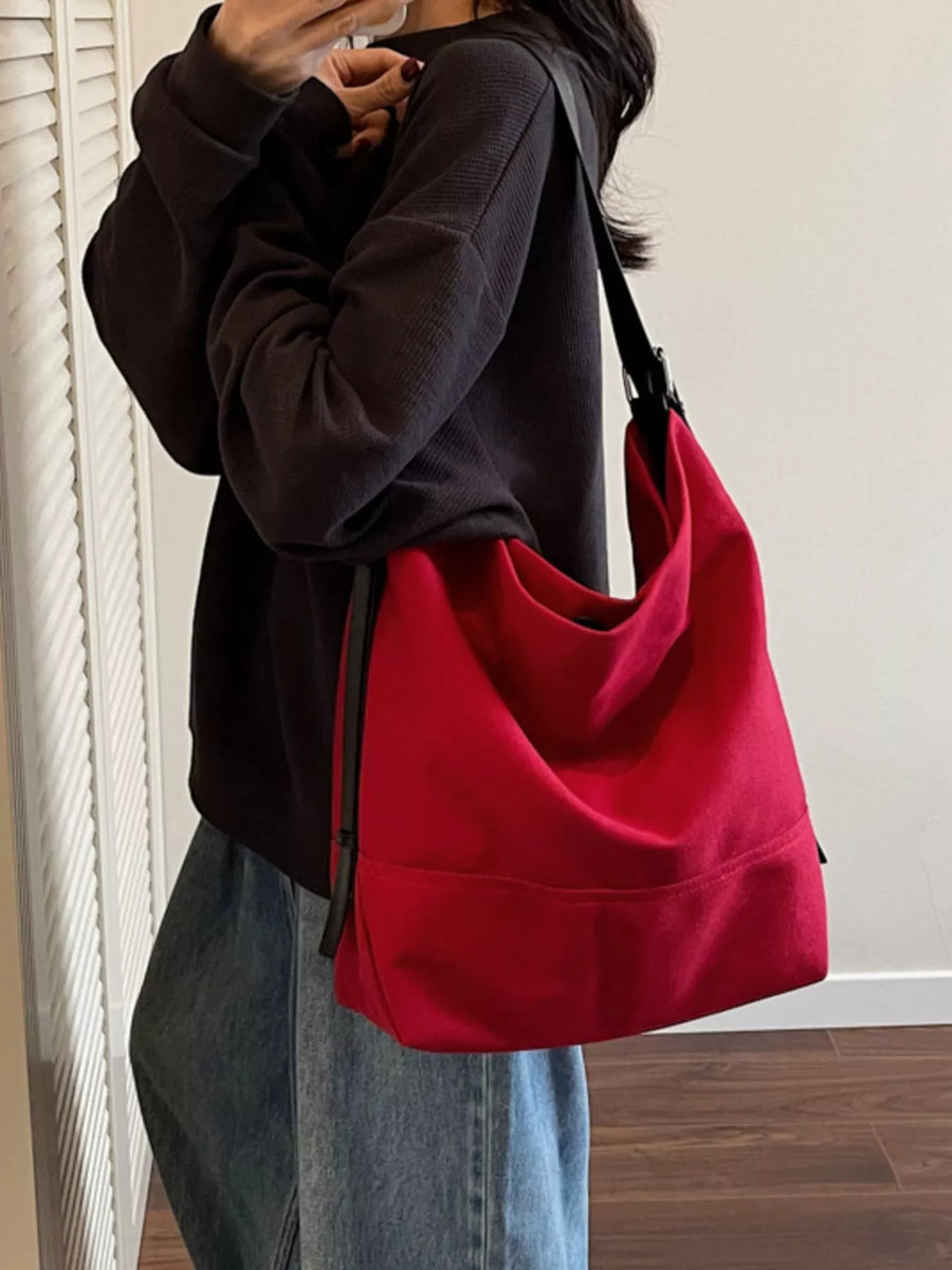 Red canvas hobo bag with adjustable strap and casual style
