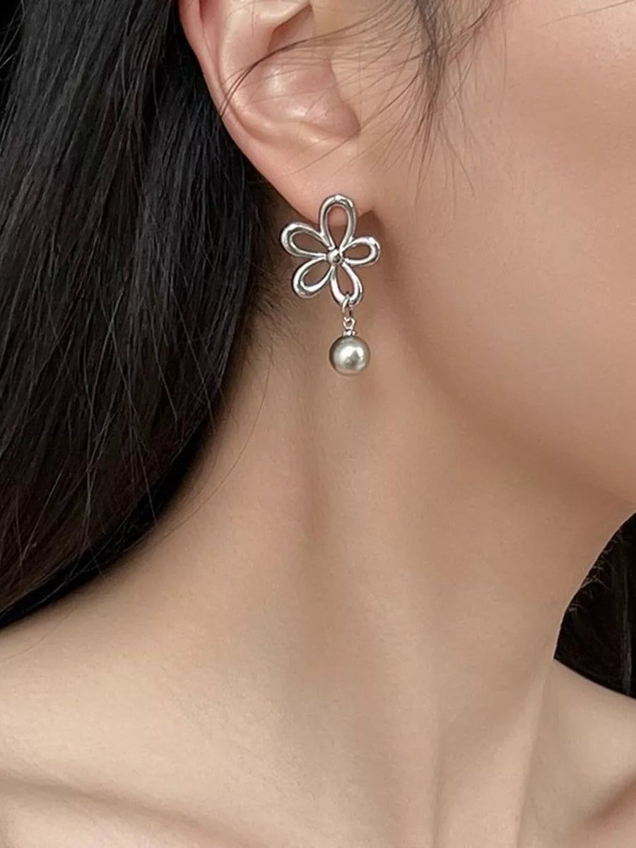 white earrings featuring drop design and floral