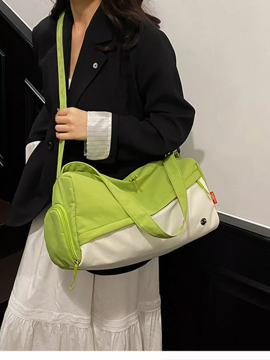 Vibrant color-block nylon travel bag with green and white panels and a zippered side pocket.