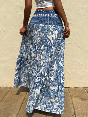Maxi skirt with blue and white paisley print, tiered design, and smocked waistband.