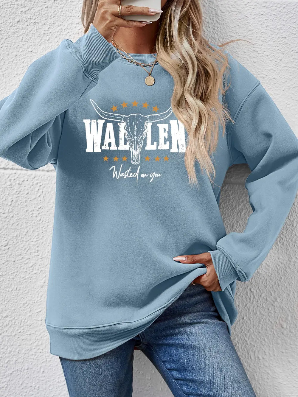 Misty Blue graphic drop shoulder sweatshirt with bull skull and text detail.